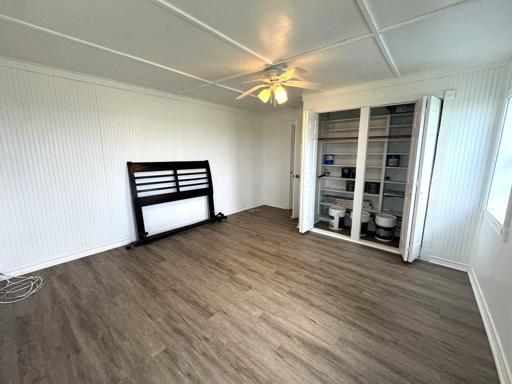 302 2nd Street Palacios, TX 77465 - Photo 8 of 45 wooden floor in an empty room with a window