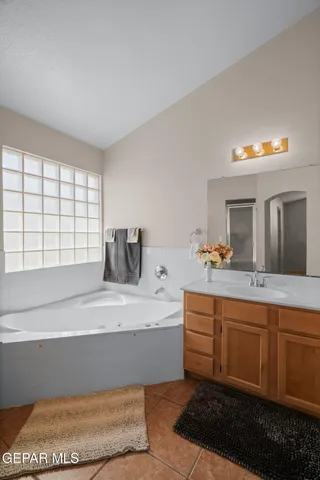 a spacious bathroom with a double vanity sink and a window