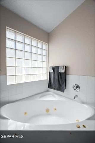 a bathroom with a bathtub and window