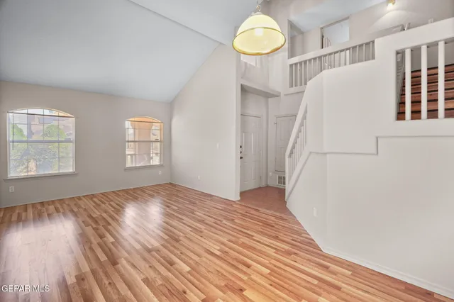 a view of a livingroom with wooden floor and window