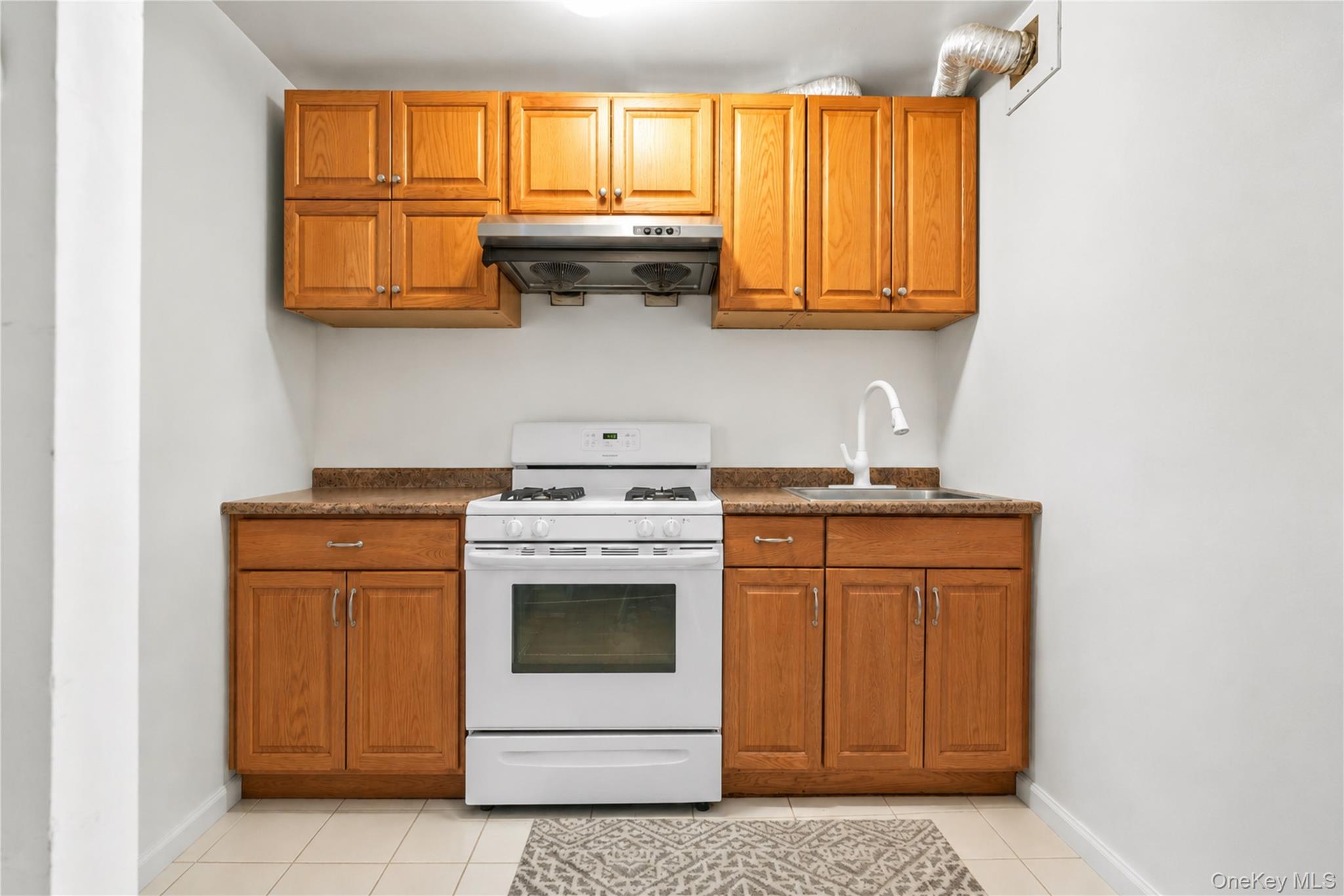 58-03 Calloway Street, Unit 5A Queens, NY 11368 - Photo 9 of 19 a kitchen with stainless steel appliances granite countertop a stove a sink and dishwasher