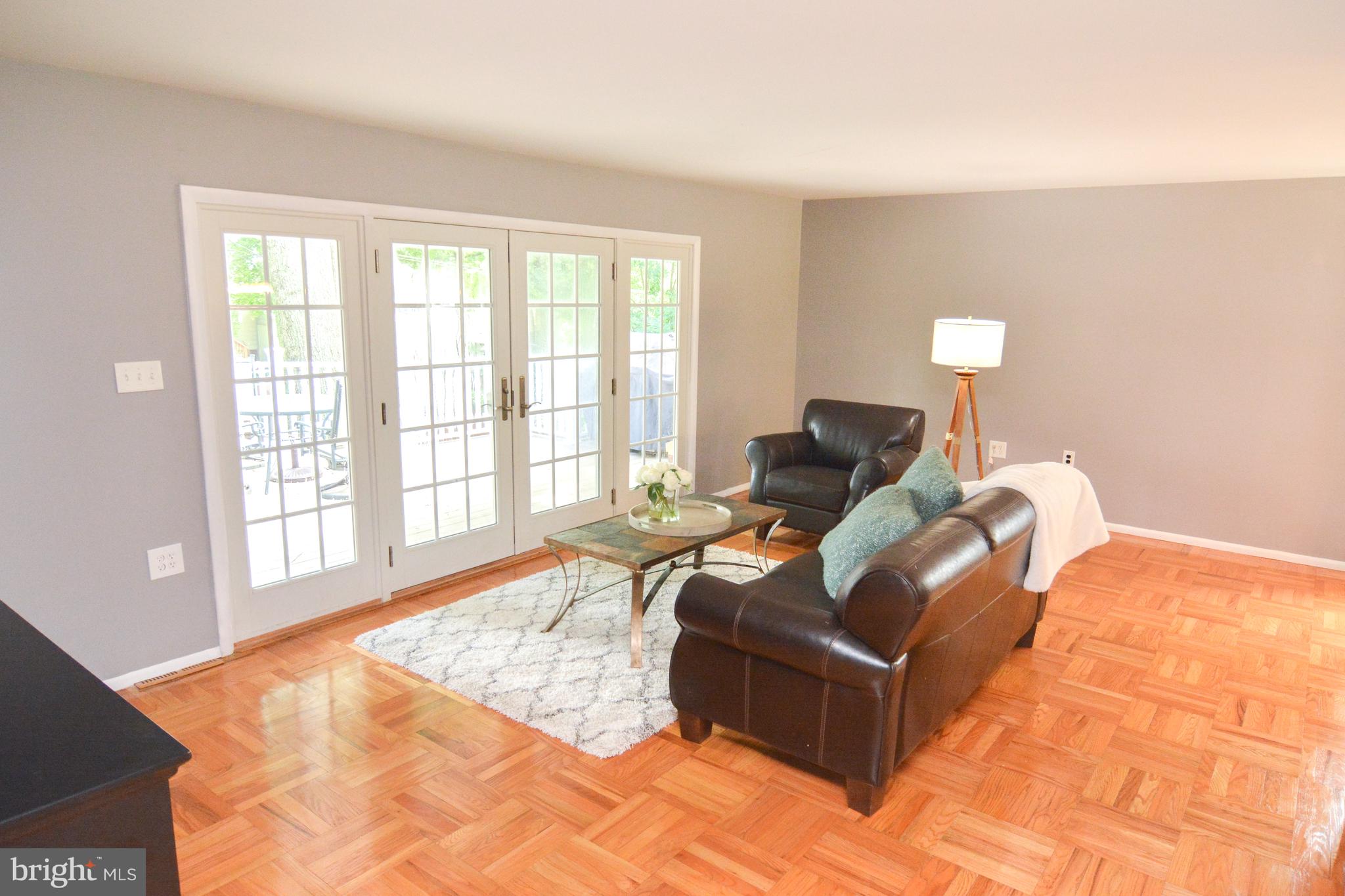 French doors open on to deck from living room