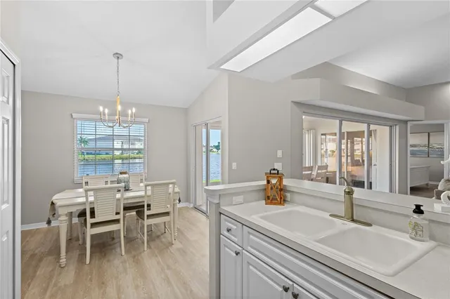 a dining room with furniture a swimming pool and glass windows