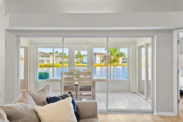 a living room with furniture a floor to ceiling window and a flat screen tv