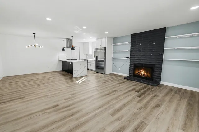 a view of a room with kitchen and fireplace