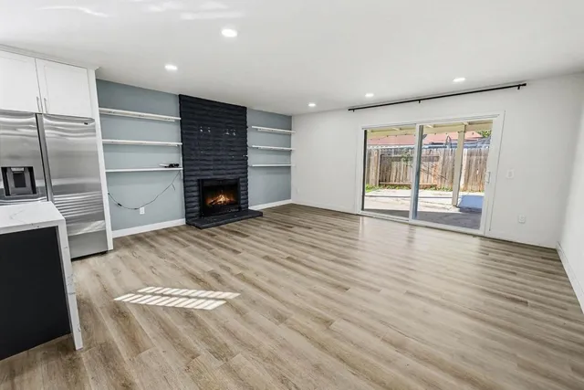 wooden floor in an empty room with a fireplace