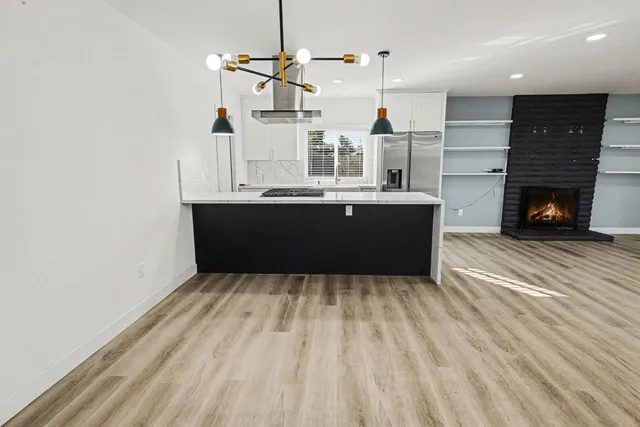 a view of a living room and kitchen with furniture