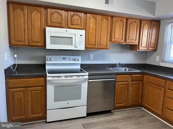 a kitchen with wooden cabinets and a stove top oven