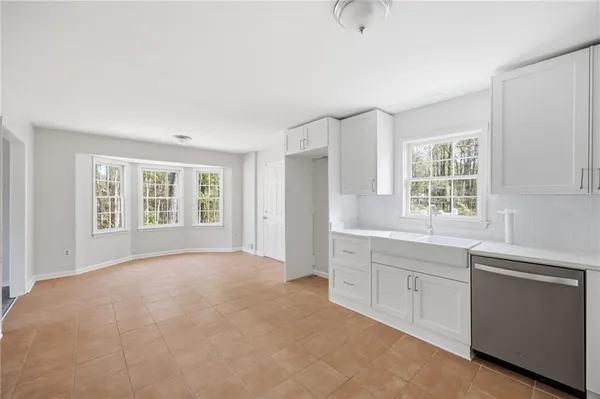 a view of a kitchen with sink cabinets and natural light
