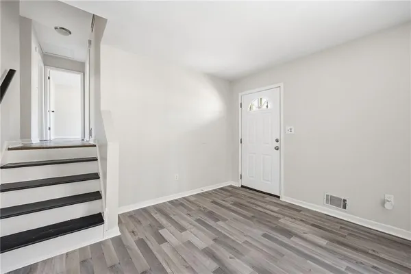 a view of a small space with wooden floor and closet