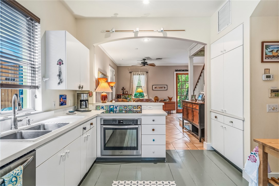 3628 Rio Vista Boulevard Vero Beach, FL 32963 - Photo 8 of 29 a large white kitchen with stainless steel appliances granite countertop a sink and cabinets