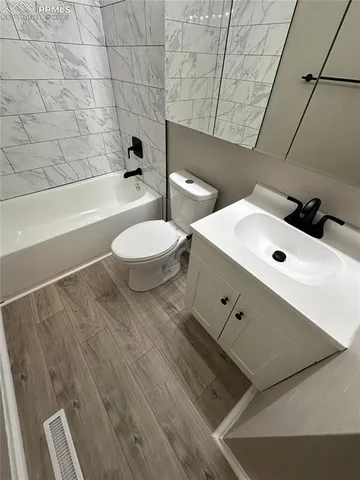 a bathroom with a toilet a sink and bathtub
