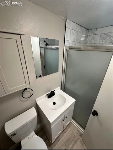 a bathroom with a sink toilet and mirror