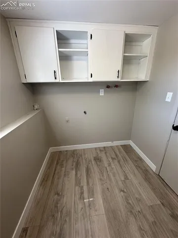 a view of an empty room with wooden floor