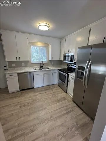 a kitchen with stainless steel appliances granite countertop a sink dishwasher stove top oven and refrigerator