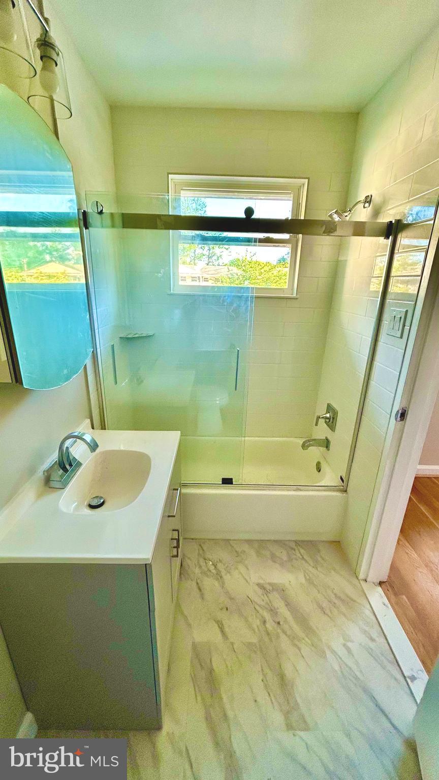 5319 Pooks Hill Road, Unit 1 Bethesda, MD 20814 - Photo 30 of 37 a bathroom with a sink a toilet and shower