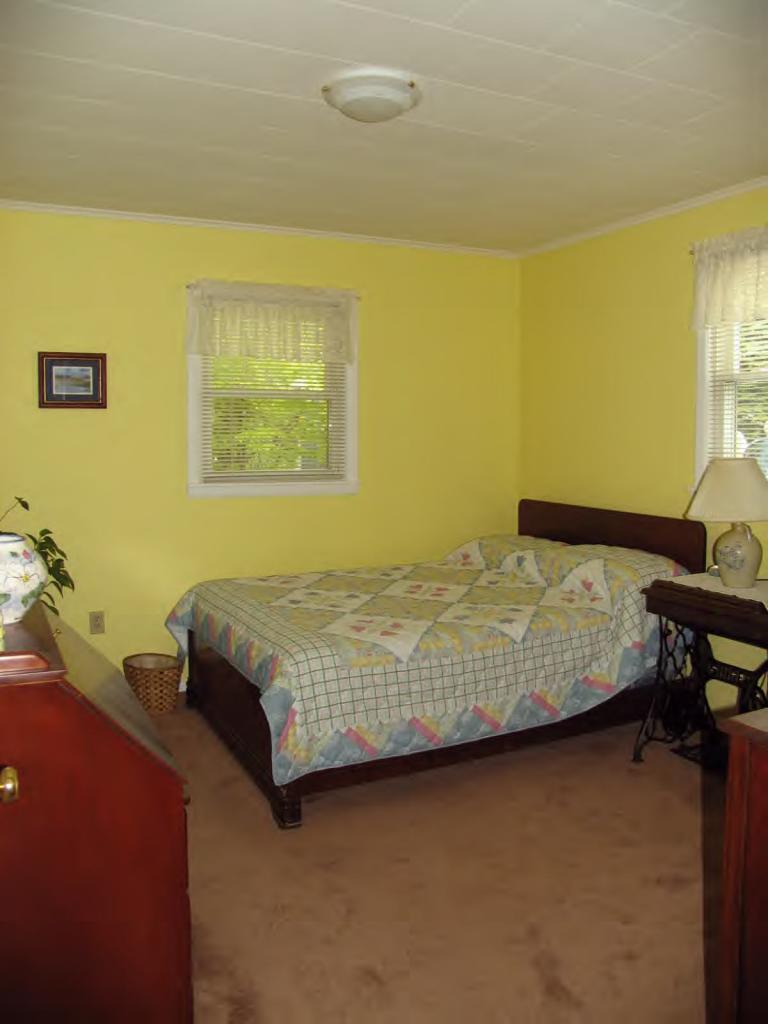 83 Lake Road Richmond, MA 01201 - Photo 3 of 6 a bedroom with a bed and wall painting