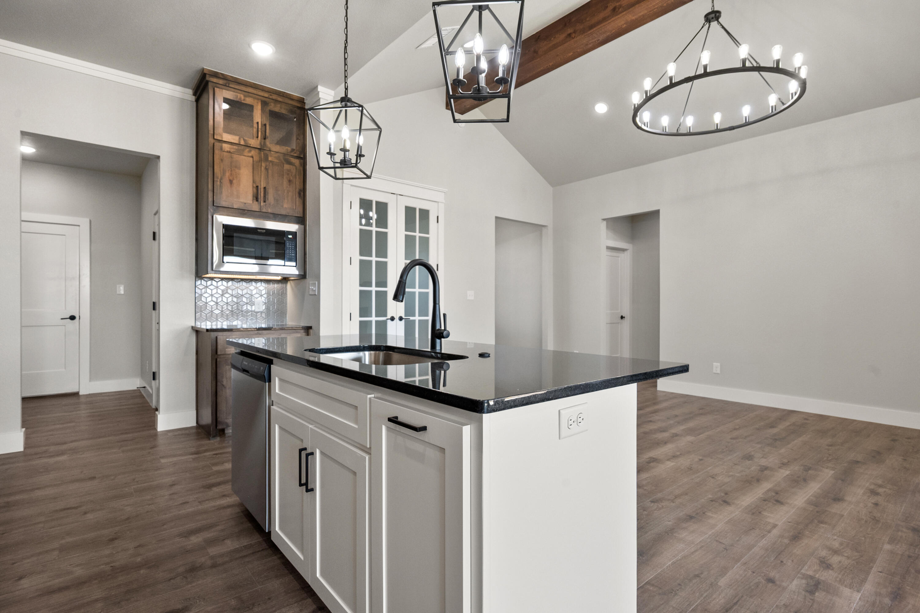1119 North 6th Street Wolfforth, TX 79382 - Photo 12 of 37 a kitchen with stainless steel appliances granite countertop a sink cabinets and wooden floor