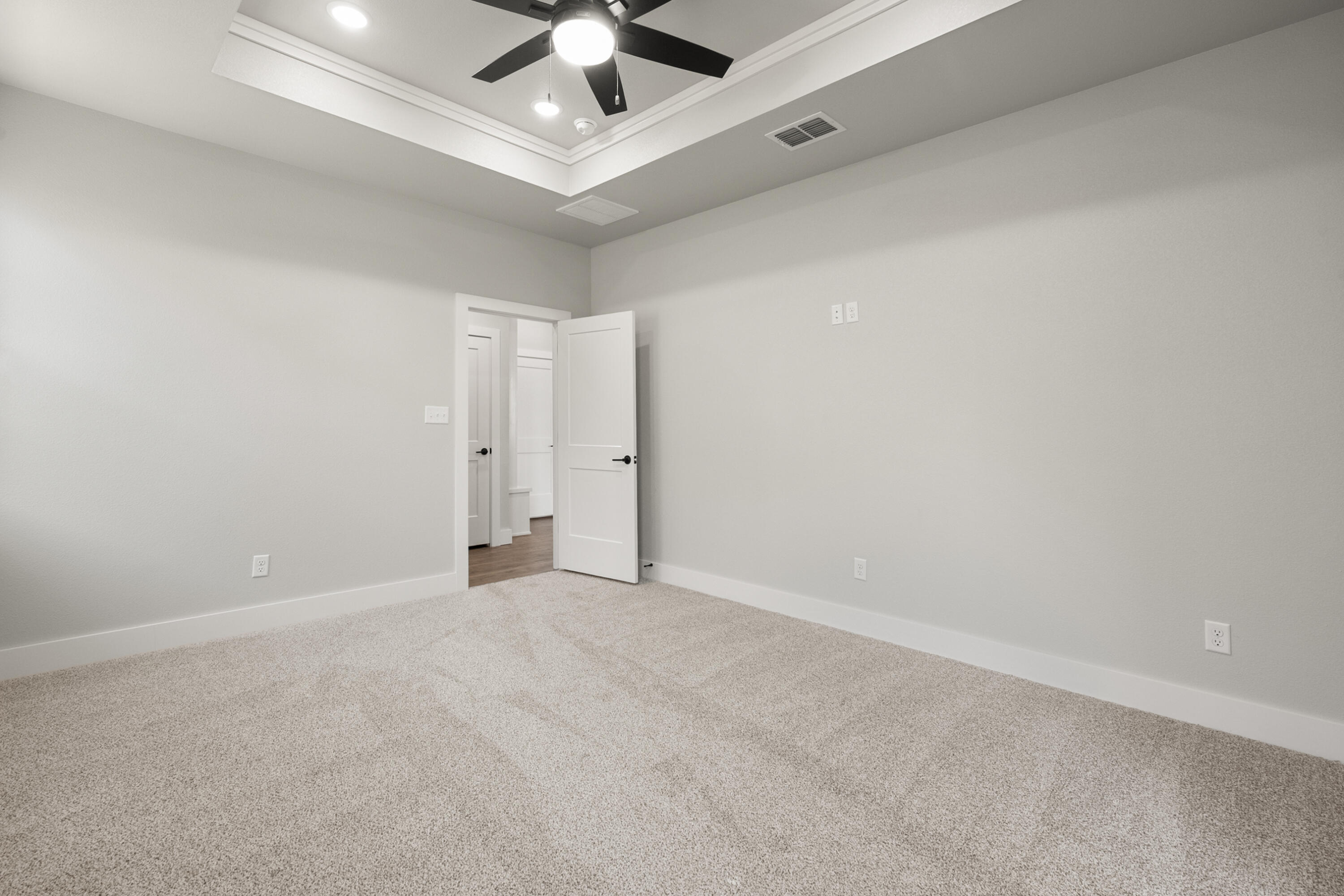 1119 North 6th Street Wolfforth, TX 79382 - Photo 19 of 37 an empty room with chandelier fan and windows