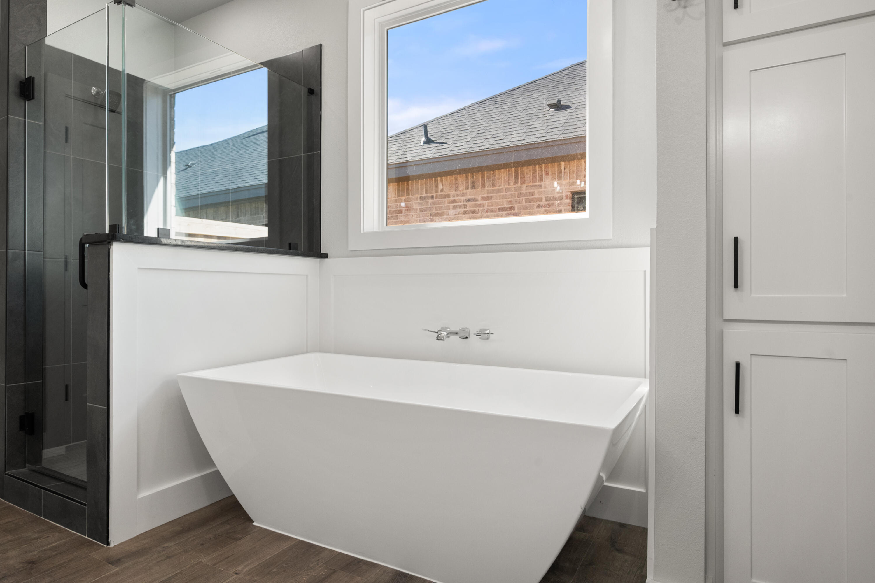 1119 North 6th Street Wolfforth, TX 79382 - Photo 23 of 37 a white bath tub sitting in a bathroom
