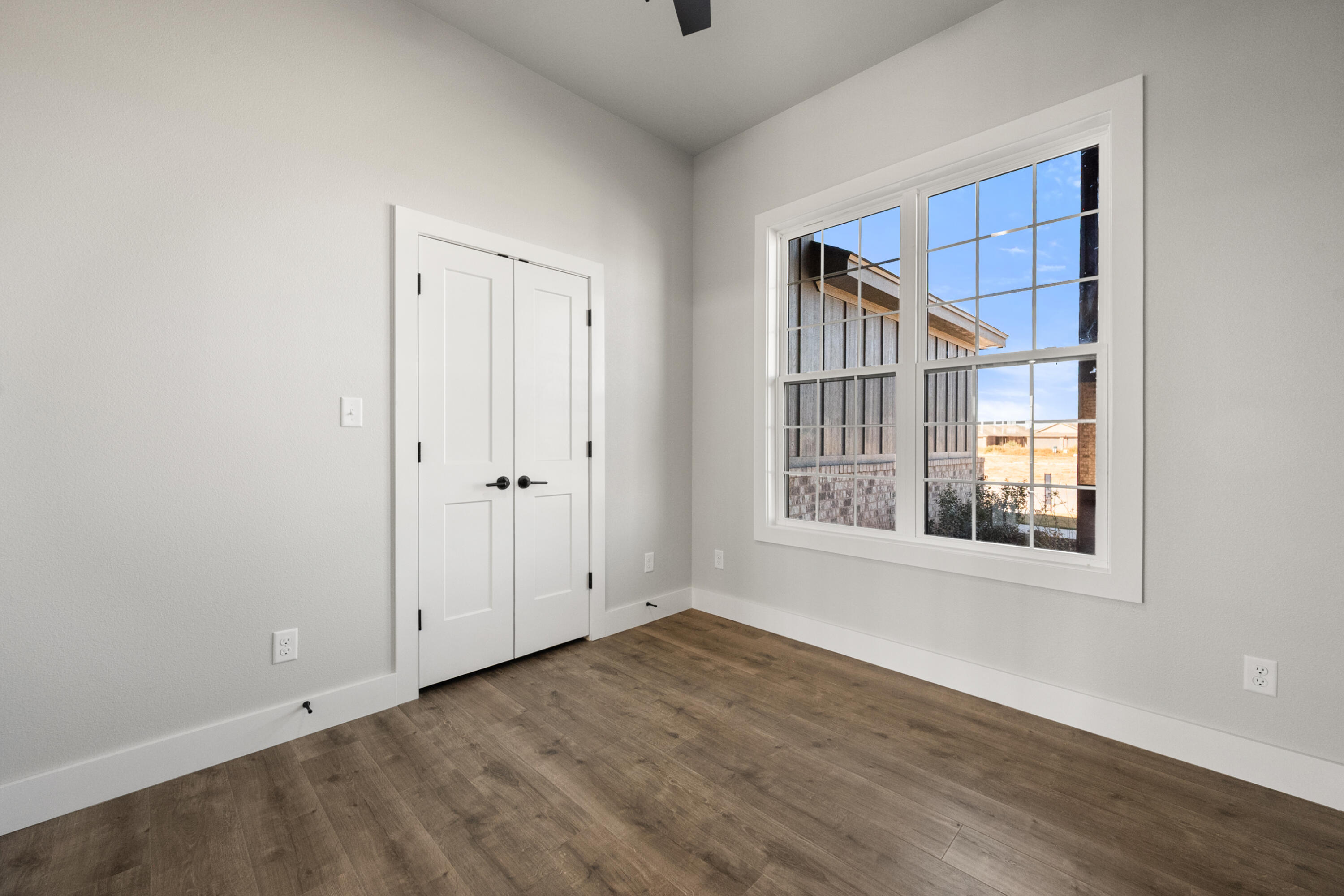 1119 North 6th Street Wolfforth, TX 79382 - Photo 24 of 37 a view of an empty room with wooden floor and a window