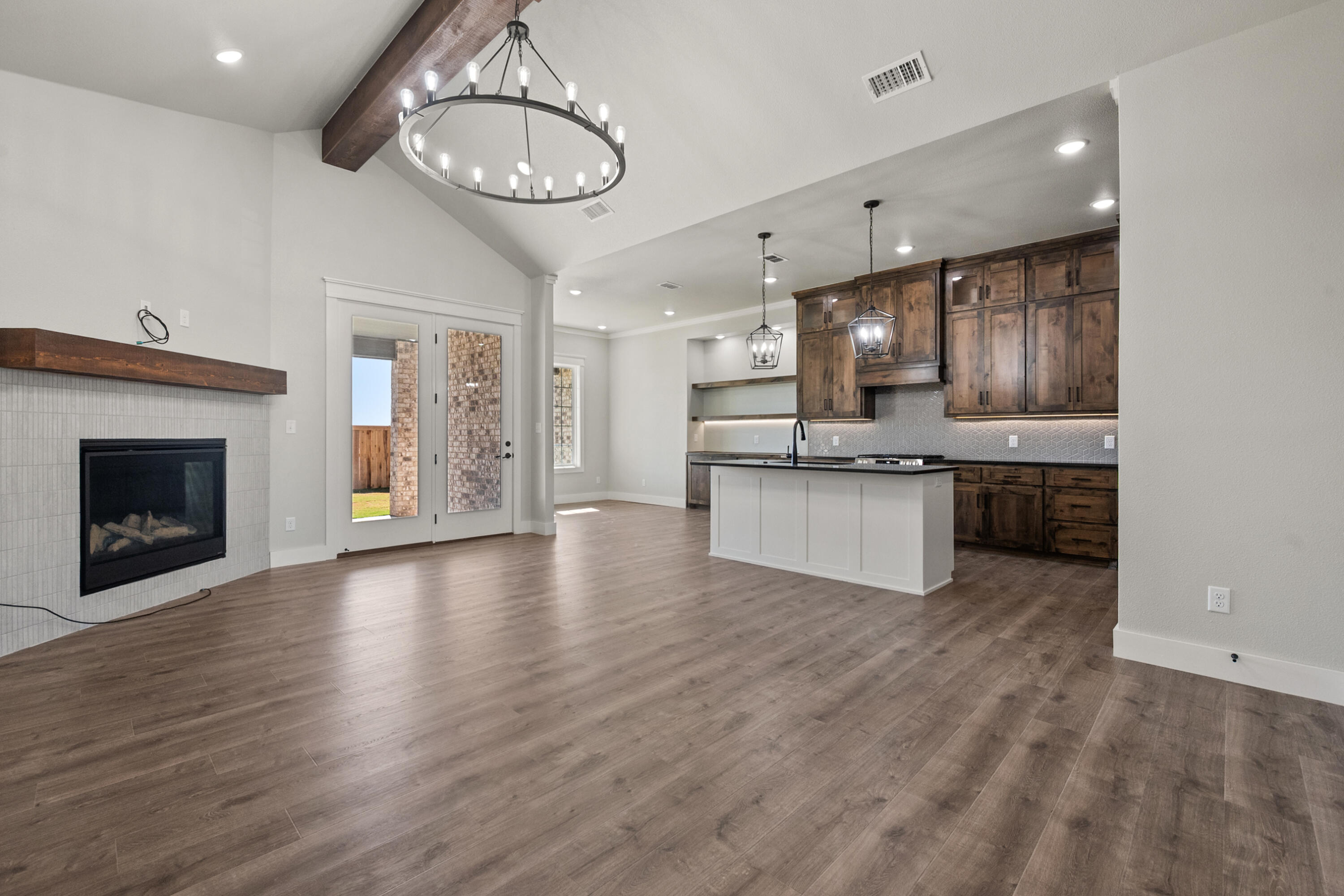 1119 North 6th Street Wolfforth, TX 79382 - Photo 4 of 37 a view of kitchen with granite countertop stainless steel appliances and wooden floor