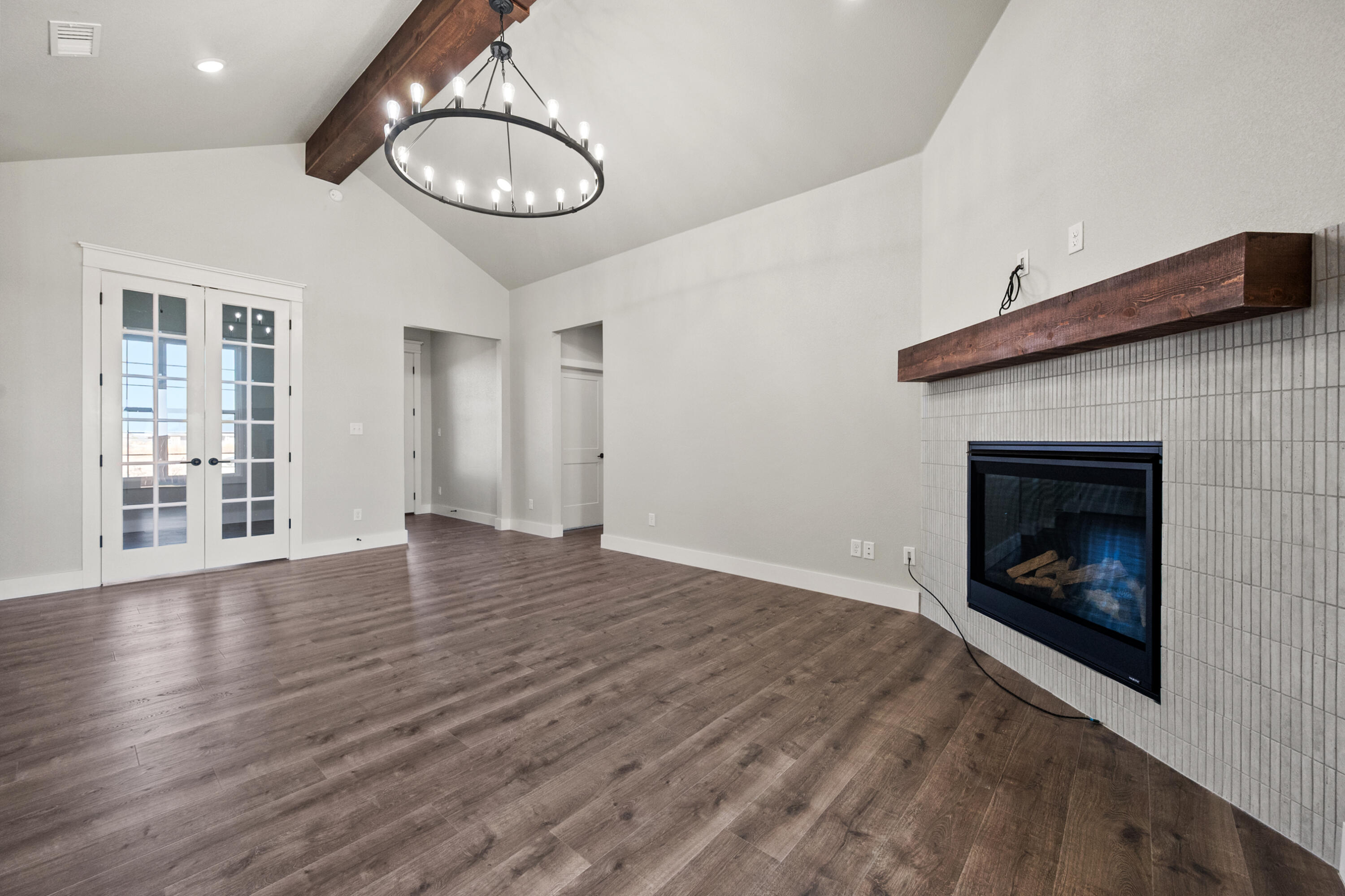 1119 North 6th Street Wolfforth, TX 79382 - Photo 7 of 37 a view of an empty room with wooden floor fireplace and a window