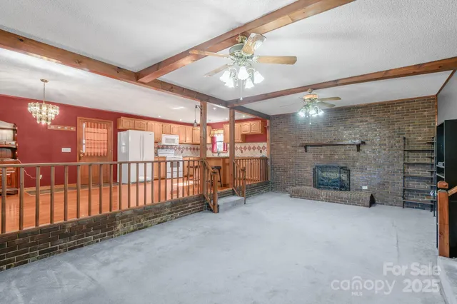a view of a livingroom with furniture and a fireplace