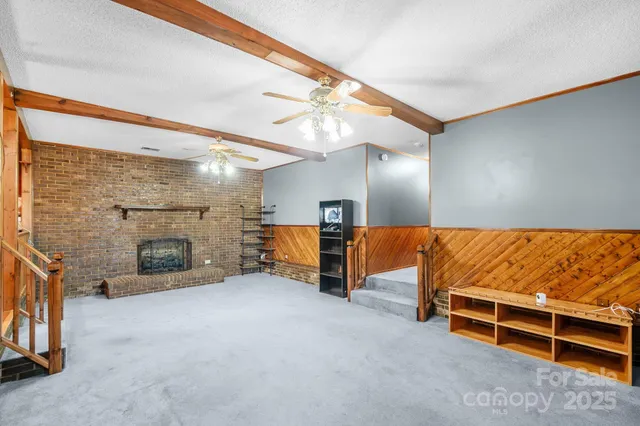 a kitchen with stainless steel appliances granite countertop a refrigerator a sink dishwasher a stove with white cabinets and wooden floor