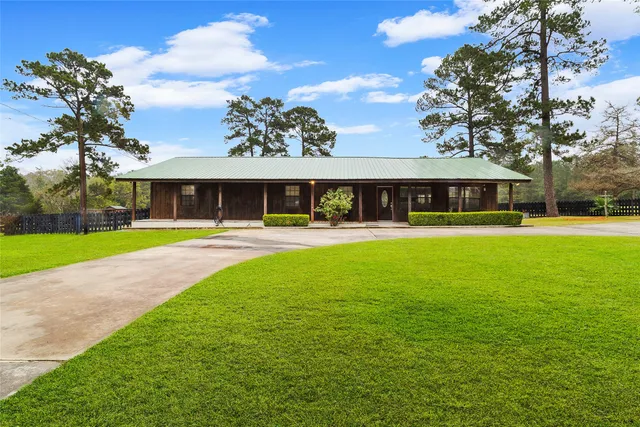 a front view of building with yard and green space