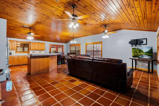 a bedroom with a bed and dresser with mirror