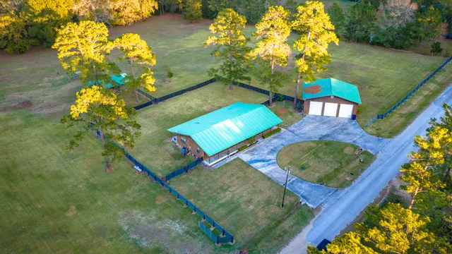 an aerial view of a house with a yard basket ball court and outdoor seating