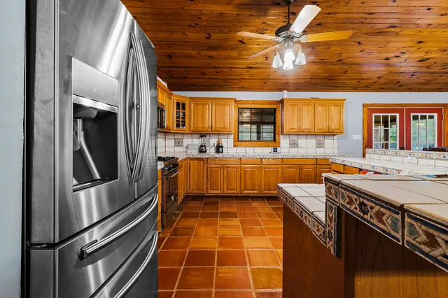 a kitchen with stainless steel appliances granite countertop a sink and cabinets