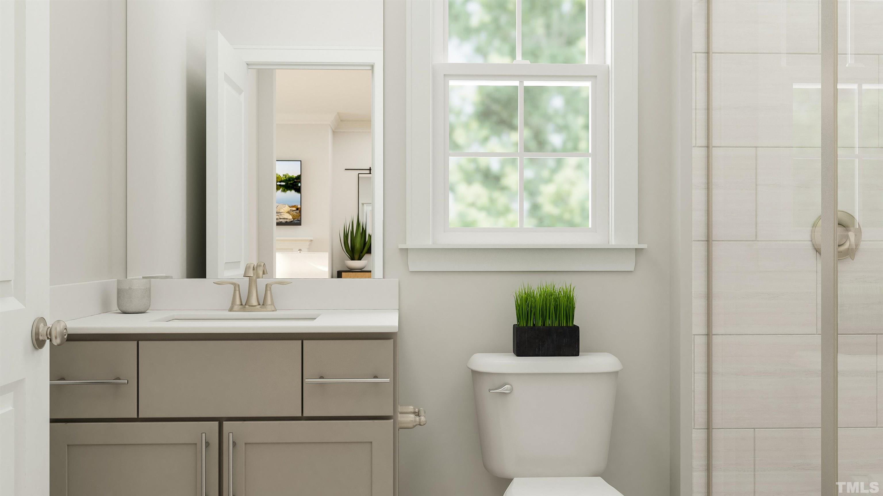 109 Calvander Lane Apex, NC 27539 - Photo 4 of 36 a bathroom with a toilet sink vanity and mirror