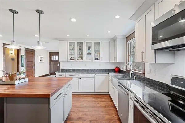 a kitchen with stainless steel appliances granite countertop a sink and a stove