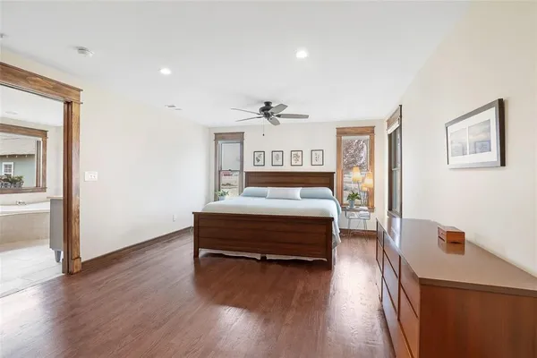 a bedroom with furniture and a wooden floor