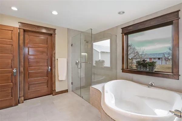 a bathroom with a bathtub and a shower