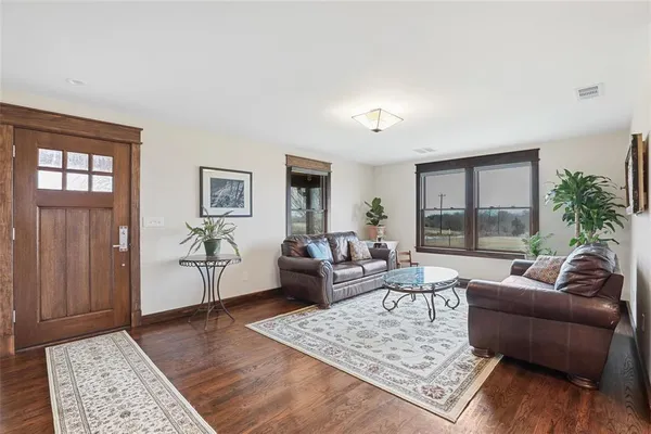a living room with furniture rug and window