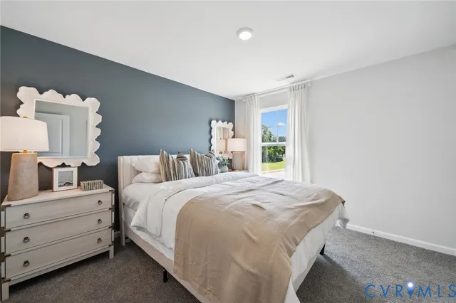 a bedroom with a bed and a painting on the wall