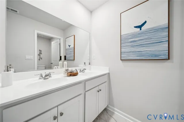 a white toilet sitting next to a bath tub