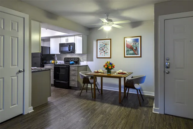a view of a dining room with furniture and wooden floor