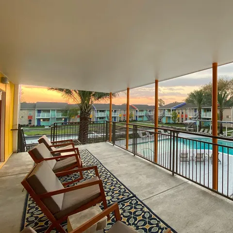 a backyard of a house with table and chairs