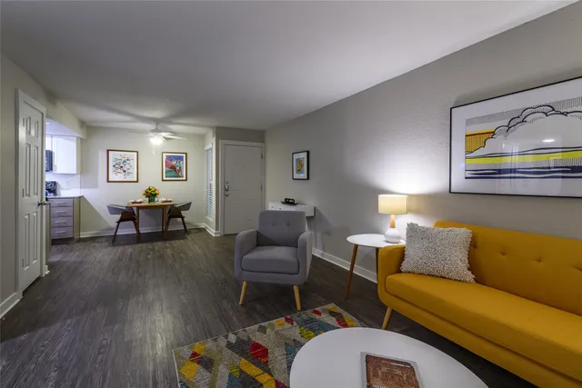 a living room with furniture and wooden floor