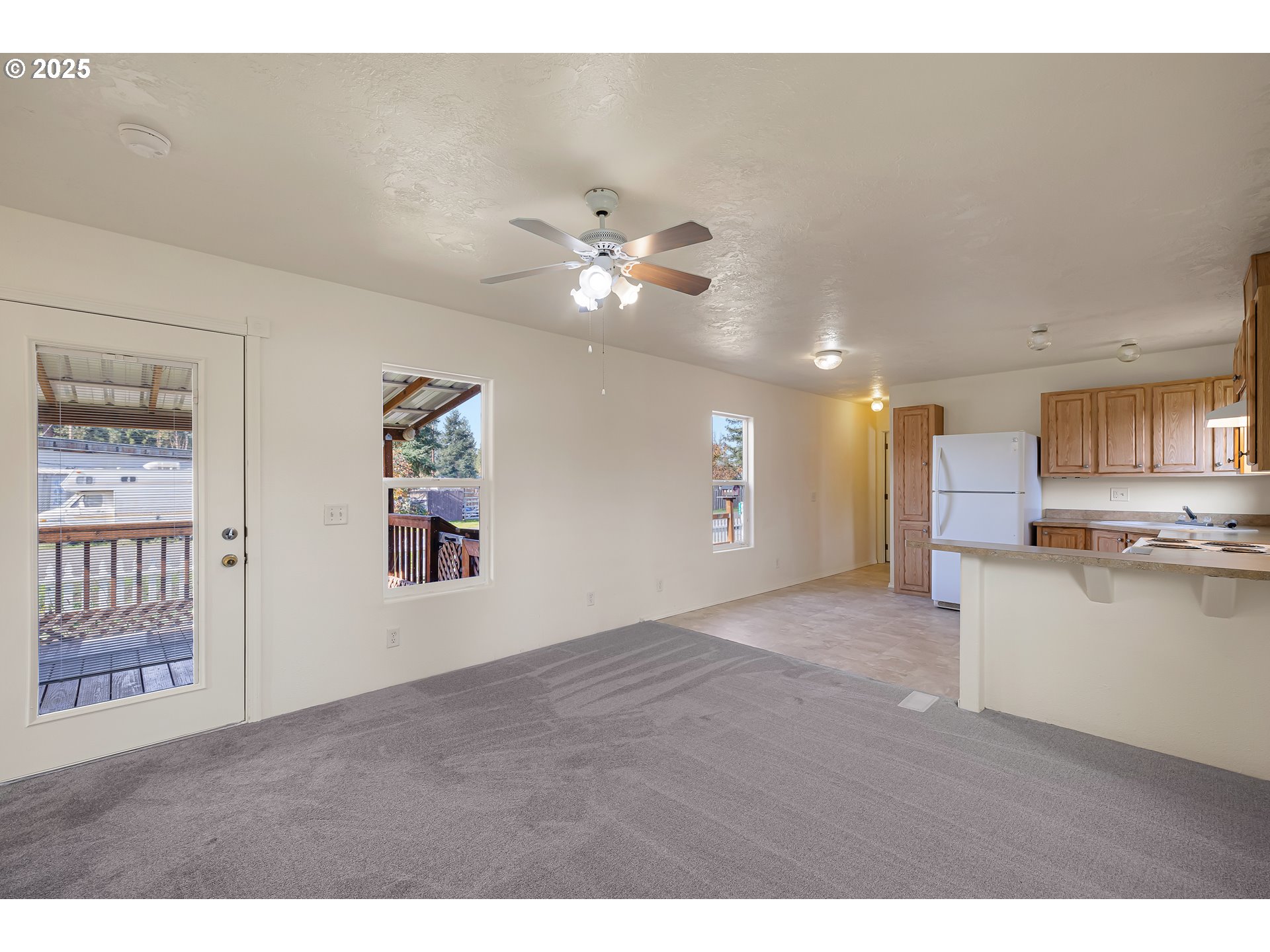 82849 Minnick Road Dexter, OR 97431 - Photo 6 of 41 a view of an empty room with kitchen view and a window