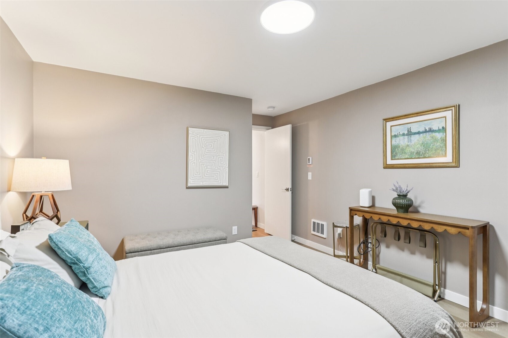 7514 43rd Avenue South, Unit B Seattle, WA 98118 - Photo 21 of 40 a bedroom with a bed and a lamp