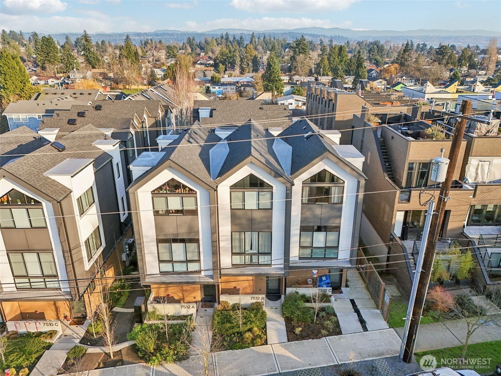 7514 43rd Avenue South, Unit B Seattle, WA 98118 - Photo 32 of 40 a front view of a houses with a yard