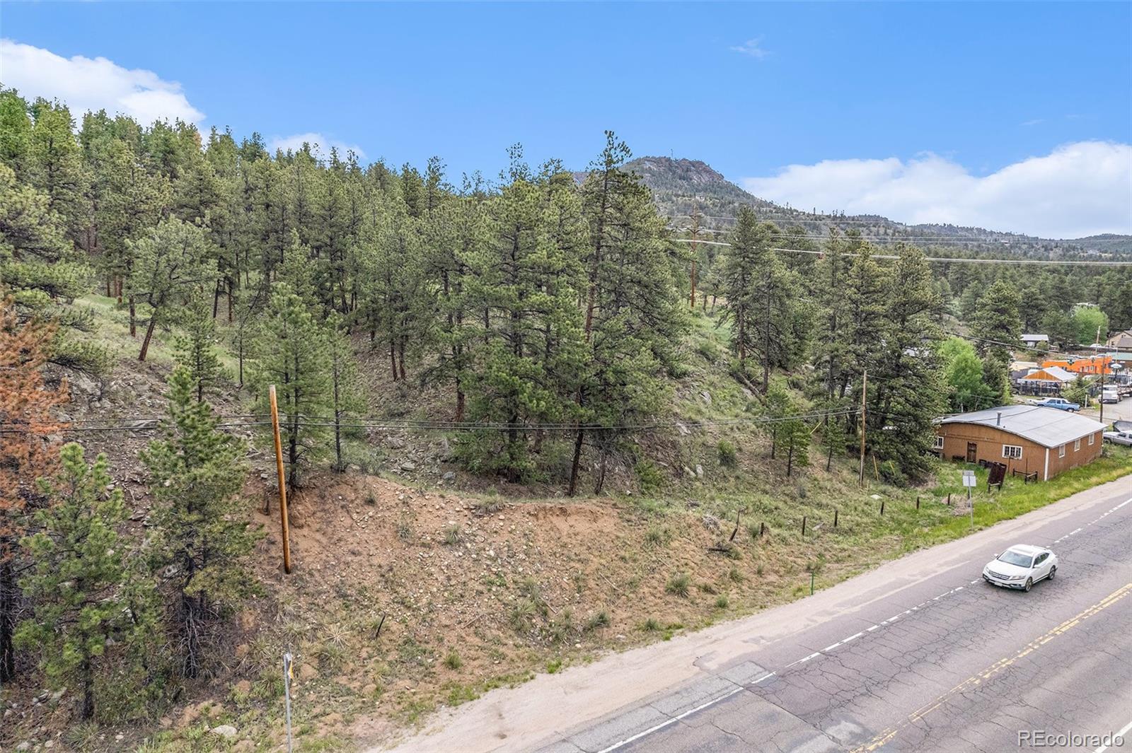 a view of a street with a mountain in the background