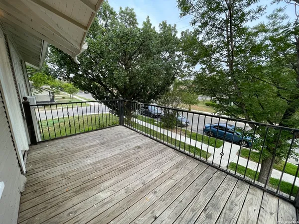 a view of balcony with wooden floor
