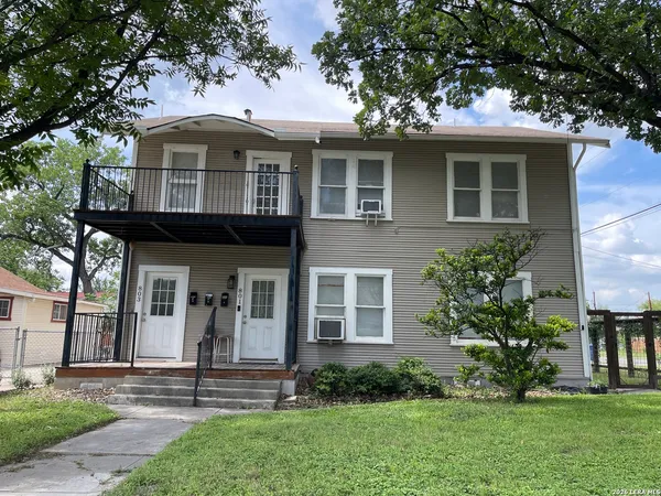 a front view of a house with a yard and porch