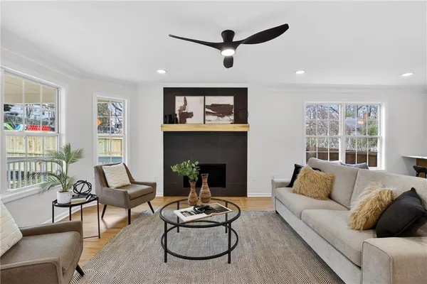 a living room with furniture fireplace and window